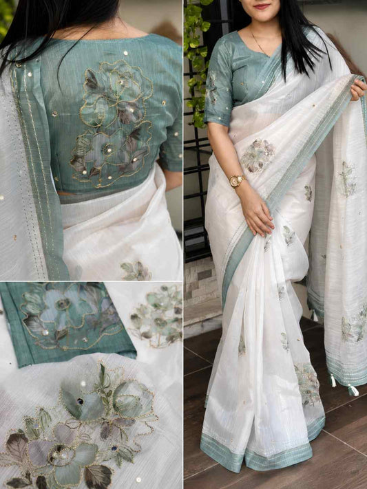 White linen saree with soft pastel green border and delicate floral embroidery